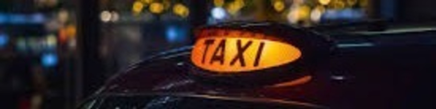London taxi sign lit at night